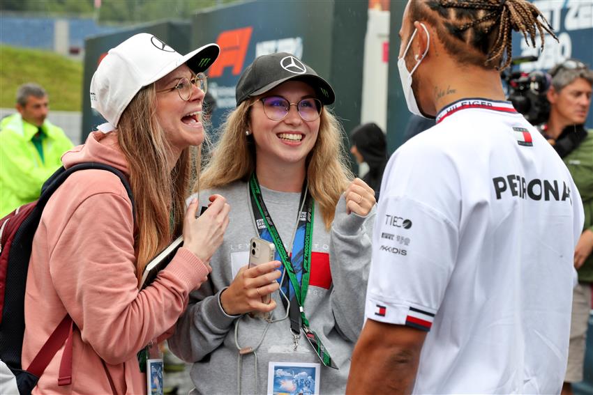 Two fans with Lewis Hamilton